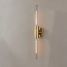 a wall light that is on the side of a wall with two lights attached to it