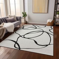 a white rug with black circles on it in a living room next to a couch