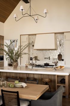 a kitchen with an island, table and chairs next to the counter top in front of it