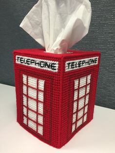 a tissue dispenser made to look like a phone booth with the words telephone on it