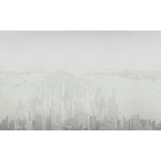 an aerial view of a large city in the foggy day with skyscrapers and water