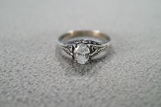 I am offering you this vintage sterling silver, wedding band stacker design ring (stamped). It features a center set prong set oval shaped genuine white topaz stone.  This stone is set in a wonderful raised relief single stone setting. Truly a most spectacular detailed scrolled filigree Victorian -style ring. It is currently a size 8, though I am sure this could easily be sized up or down. It measures app. 3/4 inch, by app. 1/4 inch. It weighs app. 4 grams.   Please review all of my pictures, as Victorian Style Rings, Silver Wedding Band, Sterling Silver Wedding Band, Vintage Wedding Band, Single Stone, Stone Setting, Topaz Stone, Silver Wedding, Ring Sterling Silver