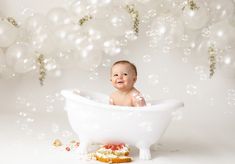 a baby sitting in a bathtub surrounded by bubbles