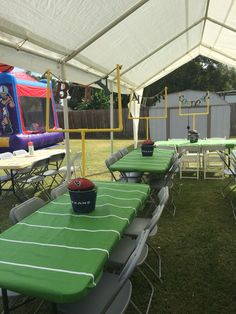 tables and chairs are set up under a tent