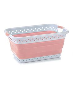 a pink and white basket with polka dots on the bottom, sitting against a white background