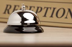 a black and white bell sitting on top of a wooden table