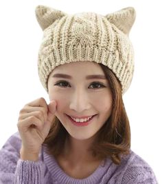 a woman wearing a knitted hat with cat ears on the front and back of her head