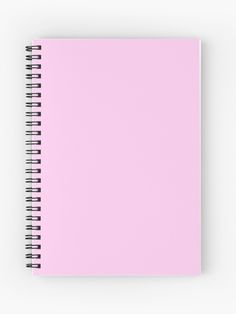 a pink spiral notebook on a white background