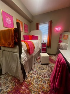 a bedroom with two twin beds in it and pink decor on the wall behind them