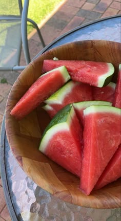 slices of watermelon in a wooden bowl on a table