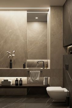 a modern bathroom with marble walls and flooring