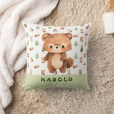 a brown teddy bear sitting on top of a pillow