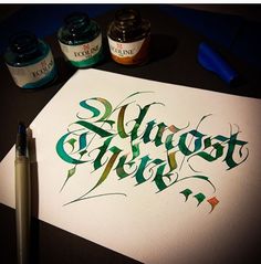 some type of calligraphy that is being worked on by someone who has done it