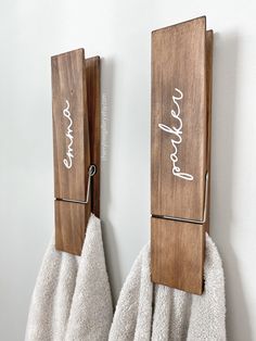 two towel holders are hanging on the wall