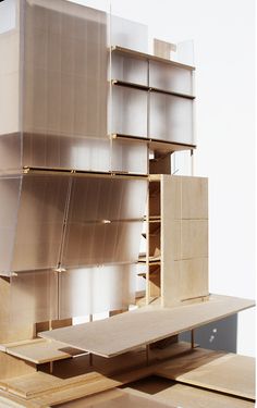 a model of a building made out of plywood and metal sheeting, with shelves on each side