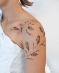 a woman with a tattoo on her shoulder