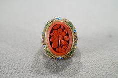 I am offering you this fabulous vintage sterling silver, with yellow gold overlay  (stamped)  band ring. This piece is distinctive and stunning with the following features: It features a large oval shaped fancy carved bezel set genuine cinnabar stone.  This stone is accented with endless amounts of scrolled filigree design work and multi colored enameling. This stone is set in a distinctive single stone raised relief  design setting. What a fantastic Art Deco style ring we have here. It is curre Heirloom Oval Engraved Enamel Ring, Heirloom Engraved Oval Enamel Ring, Victorian Oval Enamel Ring For Anniversary, Vintage Oval Filigree Ring As Gift, Antique Enamel Ring As A Gift, Oval Cabochon Enamel Rings, Oval Enamel Cabochon Rings, Oval Enamel Wedding Jewelry, Vintage Enamel Gemstone Jewelry