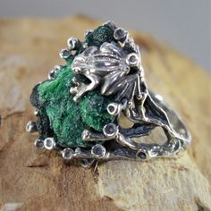 The ring of Melant is made manually of 925 sterling silver and natural plaid malachite. The ring is manually assembled directly on the stone. Each ring is individual and unique. The texture of plisse malachite resembles the interweaving of overgrown branches of a shrub, and the luster of the polished surface is akin to the dull flicker of twisted silk. Such a stone can be used in contrast with turquoise malachite - mainly as a low-expressive background. Malachite is a stone that perfectly combin Green Sterling Silver Nature-inspired Ring, Green Nature-inspired Sterling Silver Rings, Nature-inspired Green Jewelry With Raw Stone, Nature-inspired Emerald Ring For May Birthstone, Unique Green Jewelry With Raw Stone, Nature-inspired Green Emerald Gemstone Ring, Green Sterling Silver Jewelry With Raw Stone, Unique Sterling Silver Green Emerald Ring, Handmade Green Emerald Ring, Nature-inspired