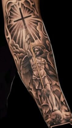 a man's arm with an angel and cross on it