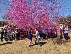 a group of people throwing confetti into the air