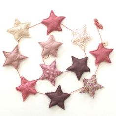 a group of pink and gold stars on a white background