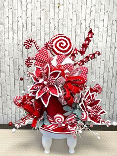 a red and white christmas tree with candy canes