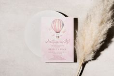 a pink and white wedding card with a hot air balloon on it