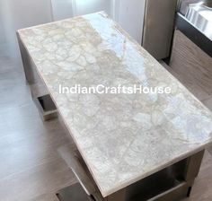 a white marble table in the middle of a kitchen