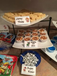 a three tiered tray filled with food on top of a counter next to other items