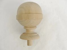 a wooden door handle on a white wall