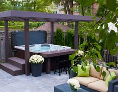 an outdoor hot tub and seating area