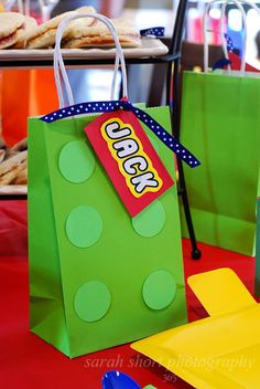 there is a green bag with a lego logo on it and some cookies in the background