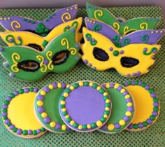 decorated cookies with mardi gras masks on them