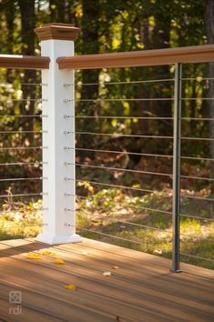 a wooden deck with white posts and rails