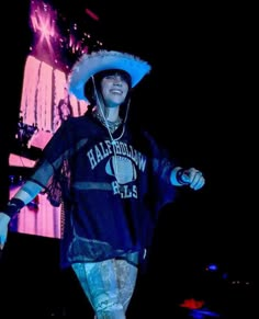 a man in a cowboy hat walking on stage