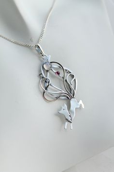 ITEM DESCRIPTION: The size of the pendant H 6 cm x W 3 cm. Weight - 3g. You can buy it with the chain at any convenient size or without. Jewelry will come to you in a gift box - ready for gift giving. I made this Kitsune necklace of sterling silver, rainbow moonstone, and rhodolite garnet. This is a fox with nine tails - a character in Japanese mythology. These animals have great knowledge, long life, and magical abilities - a very good idea for a present for someone whose you love. The parcel w Whimsical Silver Pendant Jewelry, Whimsical Sterling Silver Pendant Necklace, Whimsical Silver Round Pendant Jewelry, Whimsical Silver Round Pendant Necklace, Whimsical White Pendant Jewelry, Kitsune Necklace, Fox With Nine Tails, Hammerhead Shark Necklace, Ursula Jewelry