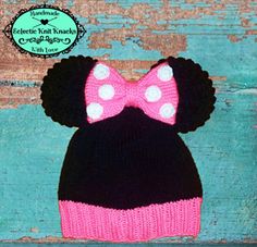 a knitted minnie mouse hat with a pink bow