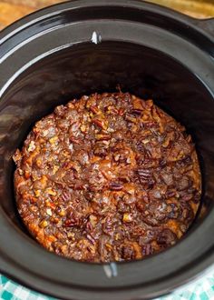 a crock pot filled with food sitting on top of a table