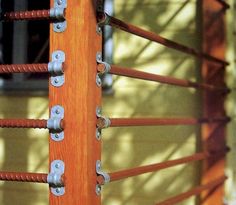 an orange wooden fence with metal bars on it