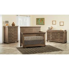 a baby crib and dresser in a room