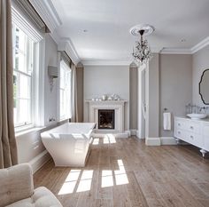 a large bathroom with a fireplace and tub