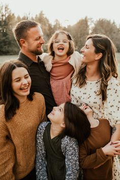 a family laughing together in an open field