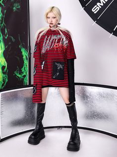 Edgy layered top featuring bold red and black horizontal stripes. Main design showcases a rebellious cat face graphic and graffiti-style text. Unique dual-sleeve effect with short striped sleeves and long black sequined sleeves for added texture. Crescent moon symbols adorn the striped sleeves. The oversized fit and mix of patterns create a striking punk-inspired look. Model info Height: 174cm Weight: 46kg Wearing size: S Red Punk Tops For Streetwear, Punk Style Red Tops For Alternative Fashion, Red Crew Neck Tops For Alternative Fashion, Edgy Red Tops For Fall, Harajuku Style Red Crew Neck Top, Red Harajuku Crew Neck Top, Red Emo Tops With Graphic Print, Red Emo Top With Graphic Print, Red Emo Graphic Print Top