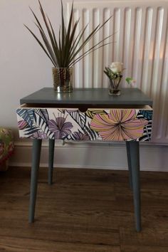 a table with two plants on it and a radiator in the back ground