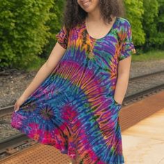 Stretchy Tie Dye Dress With Pockets. One Size Fits Most. Looks Amazing On All Sizes From 6-16 Casual Flowy Multicolor Mini Dress, Flowy Multicolor Mini Dress Casual, Purple Short Sleeve Mini Dress For Day Out, Purple Mini Dress With Short Sleeves For Day Out, Casual Purple Beach Dress, Multicolor Flowy Mini Dress With Short Sleeves, Flowy Multicolor Mini Dress With Short Sleeves, Purple Short Sleeve Summer Mini Dress, Casual Purple Mini Dress For Day Out