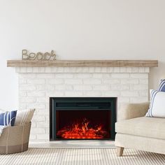 a living room with a fire place and two chairs in front of the fireplace that is lit