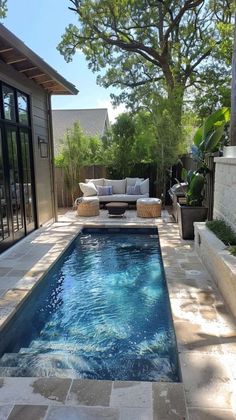 an outdoor swimming pool in the middle of a backyard