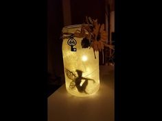 a mason jar with some lights in it