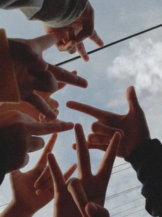 several people reaching out their hands to touch the sky