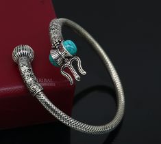 "925 sterling silver fabulous unisex vintage antique design bahubali lord shiva trident trishool with Damaroo bangle bracelet kada .Excellent handmade design open face Turquoise stone kada. Easily wearable by twisting it due to open face. amazing tribal jewelry from Rajasthan india. Metal-925 Sterling silver. Metal purity-92.5%. Brad-traditional-jewellery, Item type-Bracelet/ kada. Width of kada- 5 mm (0.5 centimeter) Size-2.375\" or 2-6 cm ,Easily wearable by twisting the bangle(see picture) In Antique Turquoise Bangle, Antique Silver Hallmarked Bangle Jewelry, Antique Silver Hallmarked Bangle, Hallmarked Antique Silver Bangle, Antique Silver Openable Jewelry, Adjustable Oxidized Jewelry For Ceremonial Occasions, Silver Openable Bangle Jewelry, Openable Silver Bangle Jewelry, Silver Openable Bracelets As A Gift